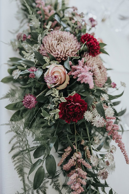 blomsterarrangemang i vinrött ooch rosa